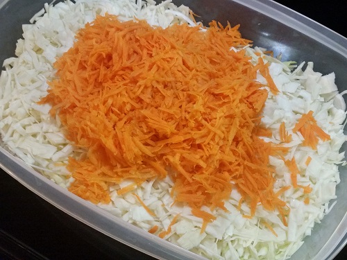 add carrots to the shredded cabbage